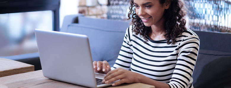 Smiling woman working on a laptop