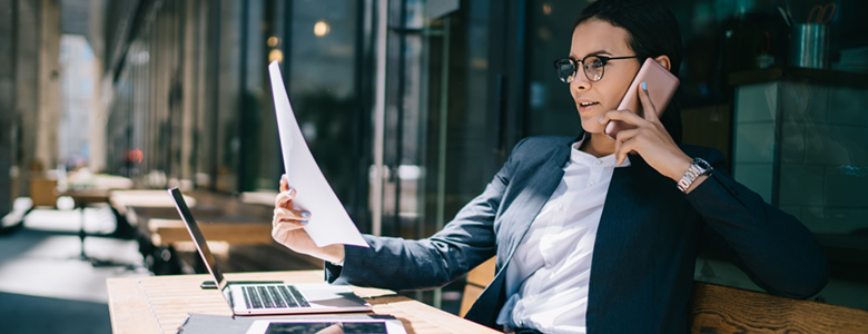 Business woman working while on smartphone